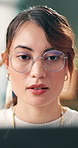 Glasses, laptop and reading with woman web designer in office for development or engineering. Computer, information and programming with design professional in creative workplace for launch or update