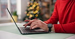 Christmas, ecommerce and hands typing on laptop, shopping and browsing online for festive gifts. Research, holiday present and person in home with computer, website and digital store for purchase.