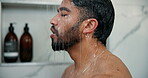Man, shower and washing face in home bathroom for cleaning, wellness and cosmetic products. Male person, house and running water in morning for skincare, splash and fresh body with profile of guy