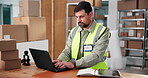 Man, typing and laptop for logistics at warehouse for research, supply chain and schedule delivery. Male person, pc and review for stock, planning inventory and shipping information for distribution