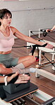 Pilates class, woman and reformer with stretching for resistance exercise, core stability or breathing. Yoga studio, people and instructor on equipment for arm strength, enhance posture and fitness