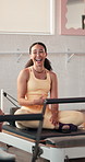 Woman, talk and laugh at pilates class with group, break or funny story with fitness on reformer. Person, friends and happy in conversation, relax and listen to gossip, joke and chat at wellness club