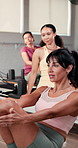 Women, fitness and instructor in gym, challenge and routine with wellness, workout and training. Showing technique, personal trainer and people in health club, endurance and support with exercise