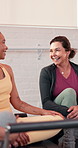 Happy, talking and women in class for pilates, yoga and exercise for wellness, break and health. Fitness group, friends and people in conversation, chatting and bonding in gym studio with machines