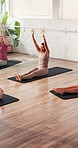 Pilates, stretching and women in class, fitness and workout routine for wellness, group and training. Active, people and exercise with instructor, healthy and warm up on mat with sportswear in gym