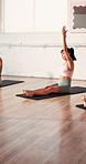 Pilates, stretching and women in class, workout and training routine for wellness, group and fitness. Active, people and exercise with instructor, healthy and warm up on mat with sportswear in gym