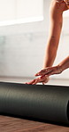 Feet, hands and rolling mat with woman in yoga studio for start of holistic or wellness routine. Equipment, fitness and getting ready with legs of yogi person in health club for beginning of exercise