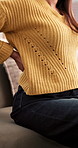 Back pain, hands and posture with woman on sofa in living room for injury, strain or massage. Accident, muscle fatigue and spine with female person in apartment for inflammation or physical recovery