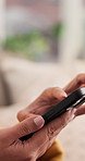Hands, woman and phone in living room for typing, scroll and text message on sofa. Female person, networking and mobile app for creating profile, chat and explore on dating website in apartment