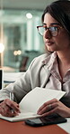 Phone, business woman and writing with notebook in office, review or agenda documentation at night. Bokeh, project management or employee with tech to record info, note taking or late schedule change