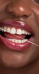 Mouth, dental floss and hygiene in studio closeup, wellness and product for plaque with fresh breath. Person, happy and string for dirt removal, benefits or cleaning teeth for gum disease prevention
