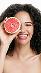 Grapefruit, cosmetics and face of woman in studio for vitamin c, treatment and skincare for smile. Portrait, fruit and model with diy facial, organic or skin detox with citrus on white background