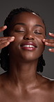 Face, skincare and happy black woman with makeup, self care and skin wellness in studio. Smile, dermatology and model with beauty cosmetics, aesthetic or collagen treatment results on gray background