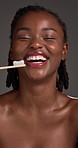 Black woman, face and toothbrush with dental hygiene for fresh breath on a gray background. Portrait, female person or African model with smile or bamboo stick for oral routine, mouth or gum care