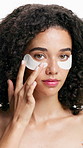 Face, skincare and woman with eye patches in studio for health, hydration or natural detox. Portrait, beauty and model apply mask for dark circles, facial treatment or dermatology on white background