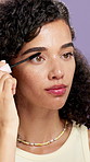 Mascara, brush and woman in studio, shine and beauty with confidence on purple background. Apply makeup product, person and eyelash extension with glow, lashes and volume with length and aesthetic
