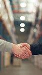 Business people, handshake and warehouse with partnership for supply chain or distribution service. Closeup, employees or shaking hands with agreement for thank you, deal or storage merger in depot