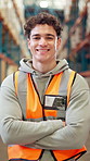 Face, logistics and man in warehouse, arms crossed and smile with distribution, confidence and shipping. Person, happy and employee in factory, supply chain and manufacturing with career ambition