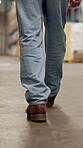 Feet, person and walking for logistics at warehouse for inspection, quality control and supply chain. Shoes, man or storage for stock check, inventory management and supervisor for cargo distribution