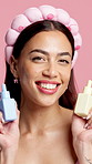 Face, serum and skincare with happy woman in studio for advertising or marketing of cosmetics. Beauty, product and recommendation with smile of person on pink background for dermatology advice