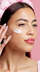 Skincare, lotion and woman with face cream for health, wellness and dermatology routine. Cosmetic, hydration and model with facial product, spf and creme for self care isolated on studio background