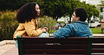Education, conversation and university student on outdoor bench, couple of friends and relax on break. Discussion, study support or people in college for bonding, social or scholarship talk on campus