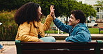 Education, high five and university student on outdoor bench, couple of friends and conversation on break. Discussion, exam pass or people celebrate on campus, social or scholarship talk for college.