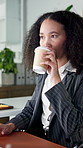 Typing, business woman and drinking coffee in office, morning beverage or thinking of investment. Tea, consultant and person with thoughts, planning or financial research at workplace with tech