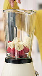 Fruit, smoothie and blender with hands in kitchen for detox, nutrition and vitamins. Health, balance diet and protein shake with person and machine in home for wellness drink, digestion and minerals