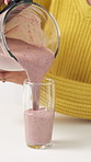 Blender, pour and woman with smoothie in kitchen for wellness, healthy diet or detox in home. Breakfast drink, morning and hands of person with beverage for nutrition, organic vitamins or weight loss