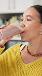 Drinking, morning and woman with smoothie in home for wellness, healthy diet and detox with vitamins. Breakfast, kitchen and person with beverage for nutrition, organic supplements and weight loss