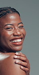 Face, laughing and skincare with black woman in studio for cosmetics or dermatology satisfaction. Aesthetic, beauty and funny with happy African model on gray background for benefits or results