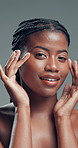 Skincare, face and black woman with beauty, self care and aesthetic on gray background. Natural cosmetics, portrait and happy model touch skin for wellness, treatment results or dermatology in studio