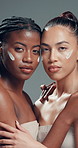 Face, women and skincare cream for beauty, dermatology and facial hydration product. Portrait, lotion cosmetics and friends in studio together with moisturizer, glow and embrace on gray background