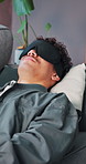 Psychology, man or counseling on sofa with blindfold for mental health, mindfulness or sensory awareness. Person, breathe or patient with sleep mask for hypnotic therapy, healing and trauma recovery.