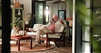 Phone call, relax and retirement with old man on sofa in living room of home for conversation. Break, communication and smile of senior person speaking on mobile in apartment for chilling or me time
