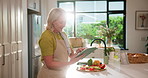 Mature woman, tablet and scroll in kitchen for thinking, vegetables and search for recipe in home. Person, chef and flare for food with tech, ingredients or cooking on app for meal prep in house
