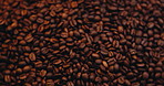 Organic, spinning and above of coffee or beans for caffeine, beverage and hospitality. Espresso product, cappuccino and latte aroma with ground roasted blend for space, cafe production and mocha brew