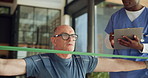 Man, physiotherapist and resistance band with clipboard, stretching and writing notes for healing process. Person, senior patient and healthcare professional for exercise, rehabilitation and advice