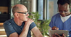 Physiotherapy, clipboard and shoulder pain with mature man in clinic for rehabilitation, healthcare or symptoms. Support, nurse and chiropractor with senior person, exam and report for healing advice