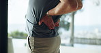 Hands, senior man and back injury in fitness with muscle tension, workout accident and inflammation. Wellness, old person or spine fracture in home from herniated disc, joint ache or training mistake