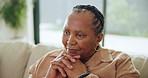 Senior woman, thinking and reflection on sofa with ideas, memory or relax in living room in Kenya. Mature African person, vision and remember on lounge couch with choice or decision in apartment