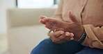 Hand pain, strain and injury with old woman on sofa for osteoporosis, arthritis and emergency. Parkinson cramp, mobility risk and anatomy with senior person in living room of home for fibromyalgia