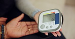 Healthcare, hands and monitor for blood pressure test in home for medical examination and hypertension. Nurse, professional and patient with machine for reading or screening of diabetes diagnosis