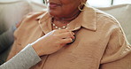 Woman, stethoscope and hands checking breathe in elderly care on living room sofa for healthcare in home. Female person, medical nurse and monitoring mature patient for cardiovascular exam in house