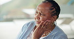 Sad, thinking and senior black woman in home with regret, nostalgia and remember memory. Depression, dementia and elderly person in living room with reflection, thoughts or loneliness in retirement