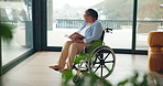 Senior woman, reading book and wheelchair in home for thinking, reflection or literature for plants. African person with disability, mobility aid or rehabilitation for injury with story in retirement