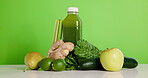 Vegetables, health and fruit with juice on table for nutrition, detox drink and wellness. Supplement, vitamins and weight loss with smoothie on green background for mockup space and organic beverage
