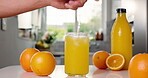Nutrition, orange or person in kitchen with straw, antioxidant or vitamin c benefit in morning drink. Organic, citrus and hand in home with stirring, gut health or digestion in breakfast beverage.