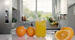 Nutrition, juice or glass in kitchen with orange, antioxidant or vitamin c benefit in morning drink. Organic, hydration or fruit in home with detox diet, gut health or digestion in breakfast beverage